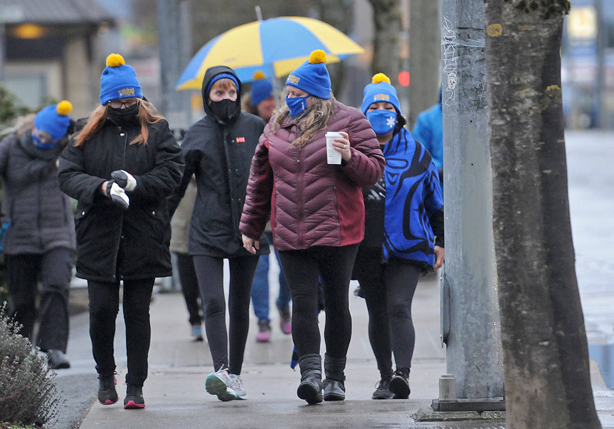 A team with Ann Davis Transition Society takes part in the Coldest Night of the Year fundraiser as they walk along Young Road on Saturday, Feb. 22, 2021. (Jenna Hauck/ Chilliwack Progress)