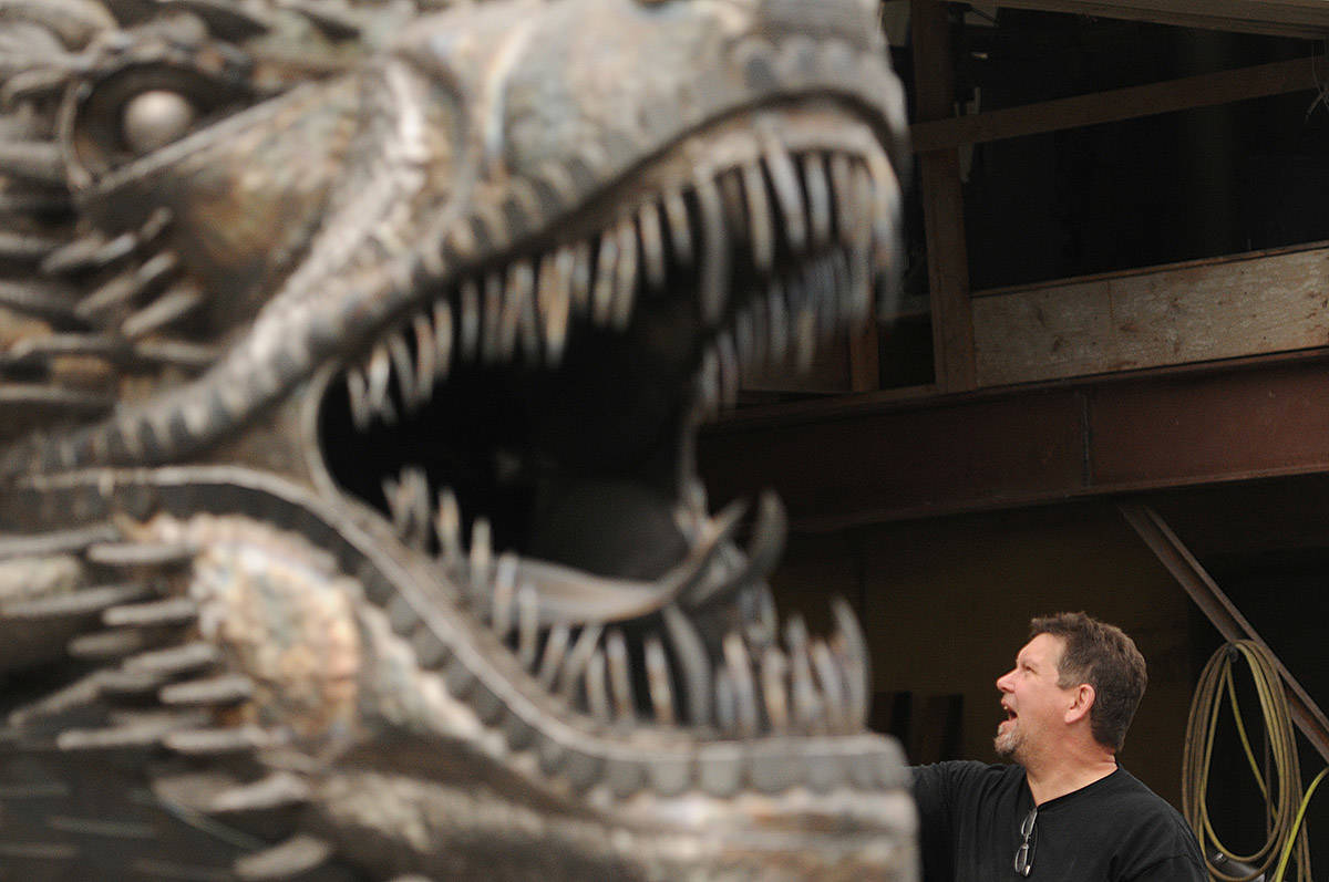 Kevin Stone helps move his 8,000-pound unfinished steel dragon from Stones Speed Shop to a new location in Yarrow on Thursday, April 29, 2021 (Jenna Hauck/ Chilliwack Progress)