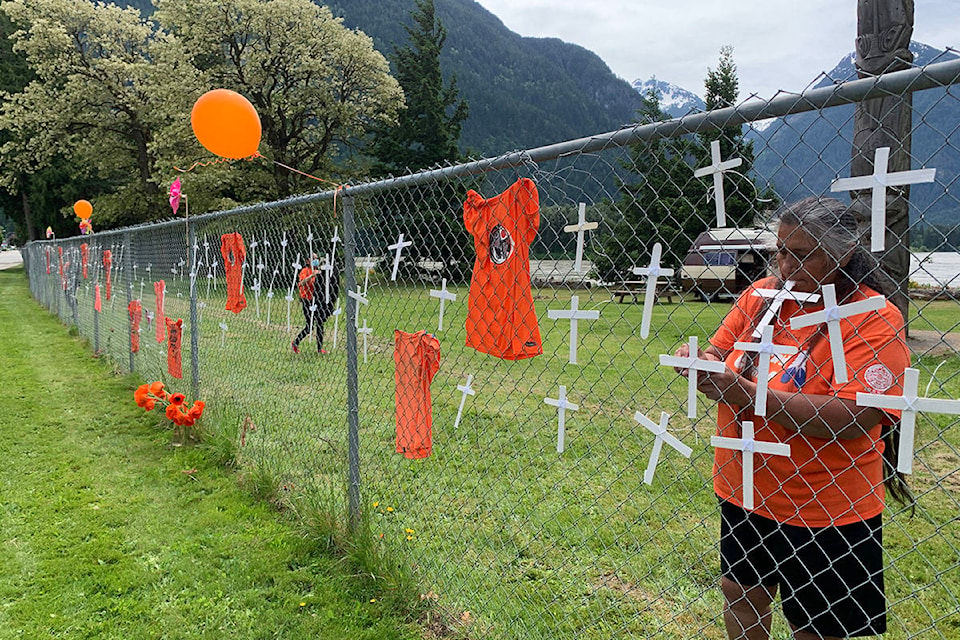 Hope area residents placed handmade crosses and orange shirts along Water Avenue in Hope on May 31, 2021, in honour of the Indigenous children who died at residential schools. (Jessica Peters/ Hope Standard)