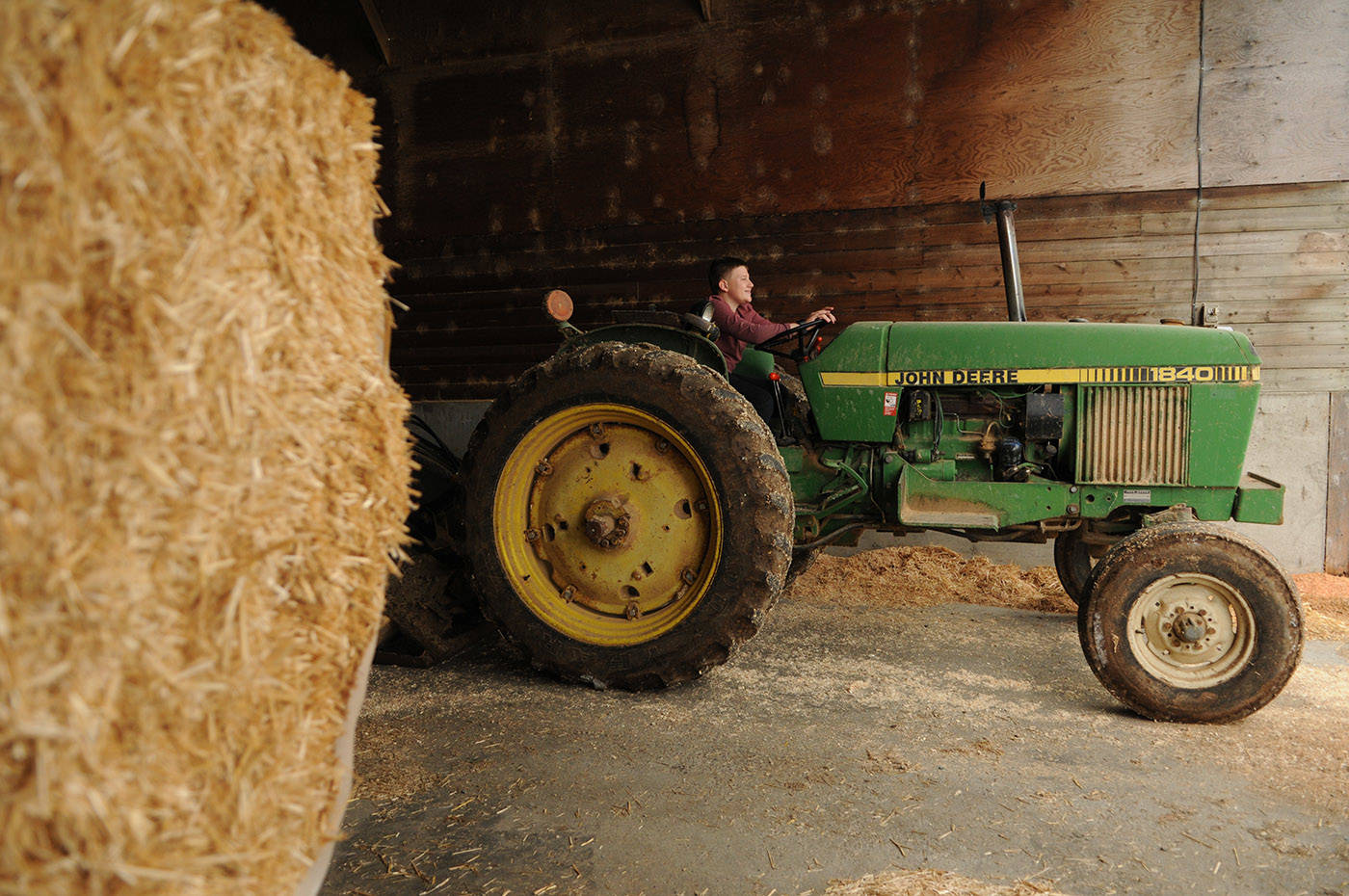 Winston Sache, 11, sits in a tractor at his home, West River Farm, in Chilliwack on Tuesday, June 15, 2021. (Jenna Hauck/ Chilliwack Progress)