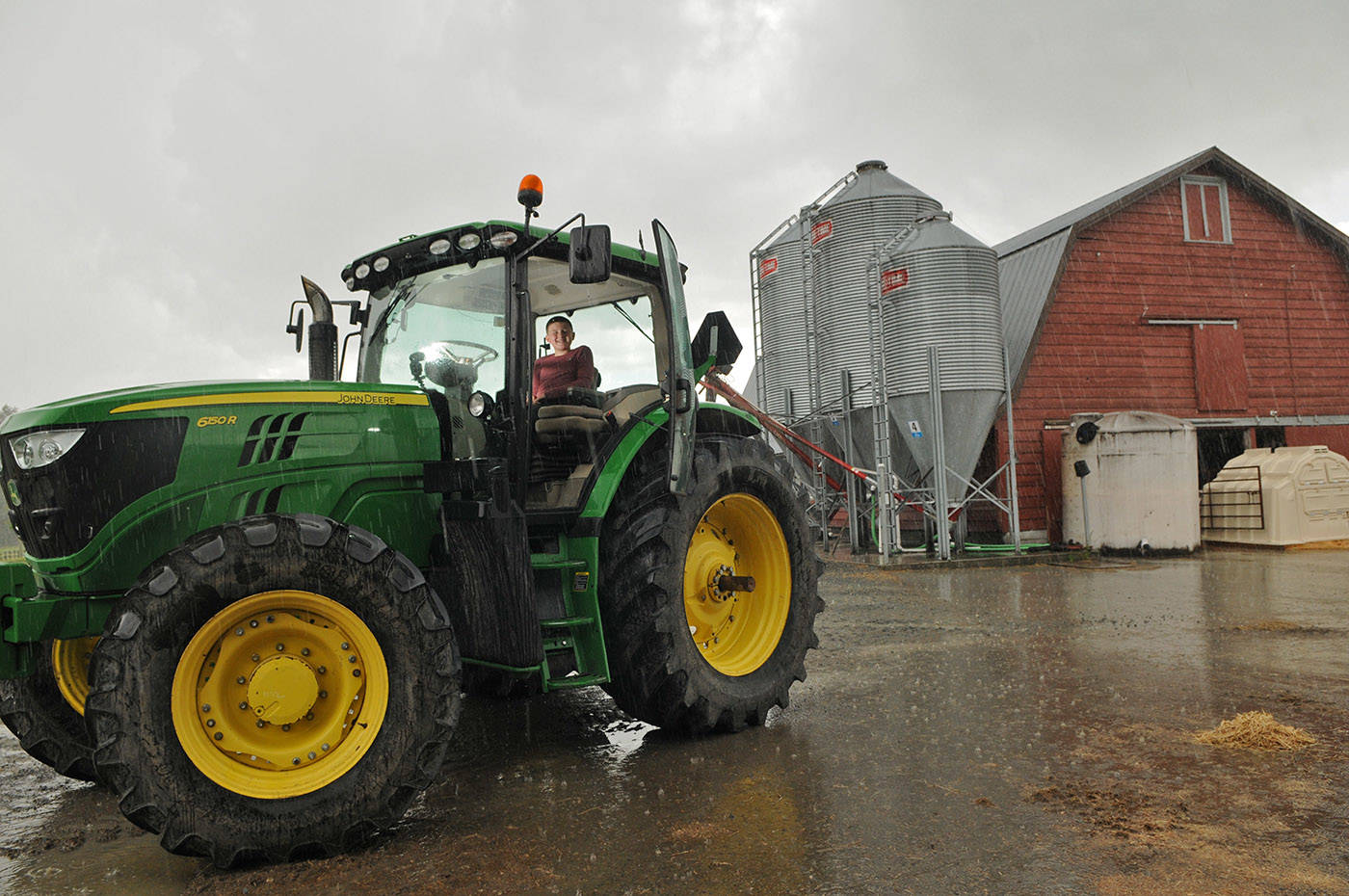 Winston Sache, 11, sits in a tractor at his home, West River Farm, in Chilliwack on Tuesday, June 15, 2021. (Jenna Hauck/ Chilliwack Progress)