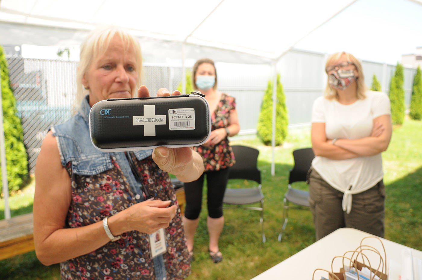 Kim Lloyd, program supervisor with Pacific Community Resources Society (PCRS) in Chilliwack, holds up a naloxone kit during a free friends and family naloxone training workshop at Chilliwack Health and Housing Centre on Tuesday, June 22, 2021. (Jenna Hauck/ Chilliwack Progress)