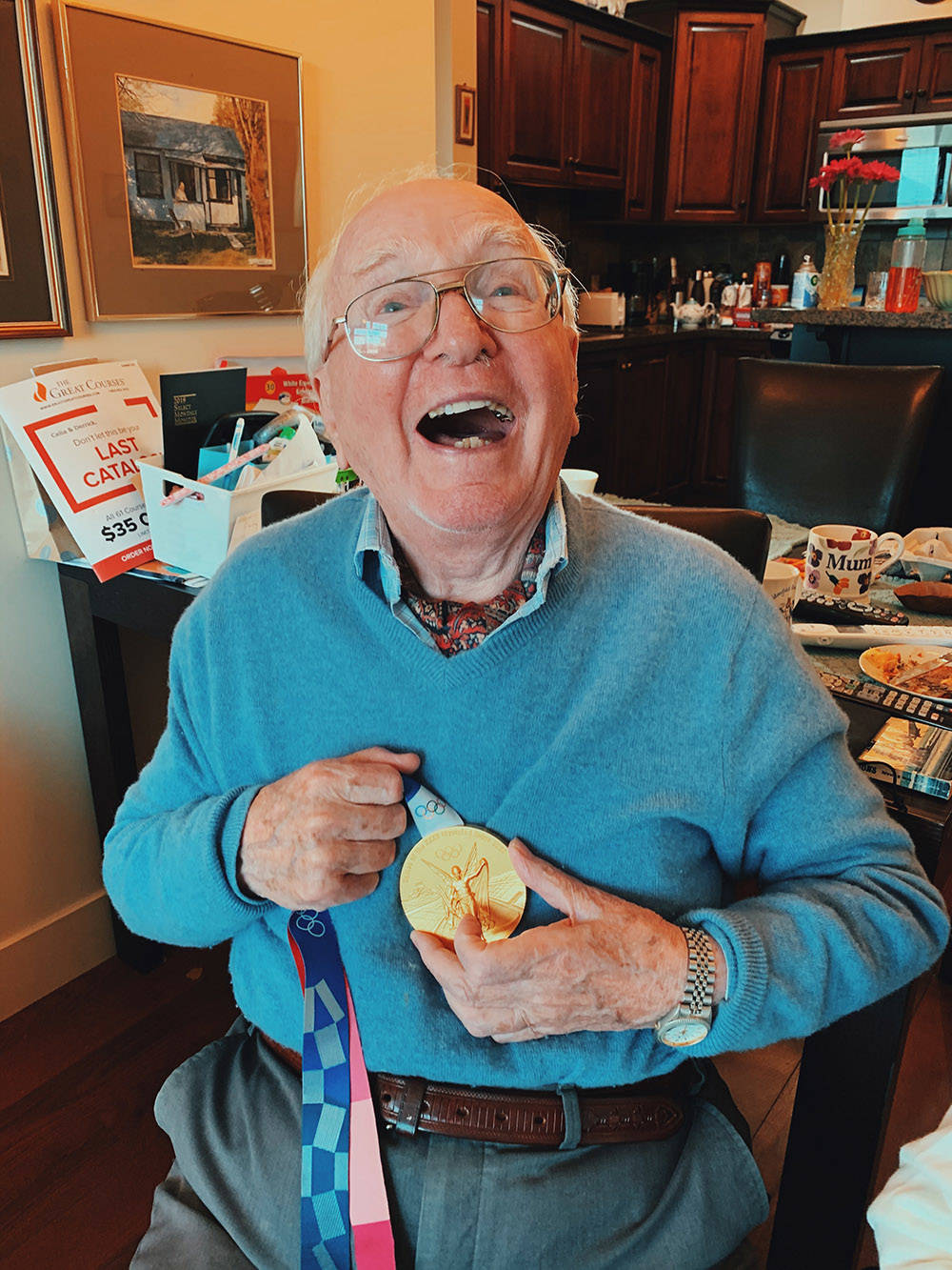 Herbert Rogers of Chilliwack holds his granddaughter Madison Rogers-Maileys Olympic gold medal for womens eight rowing in Tokyo, Japan. (Submitted)