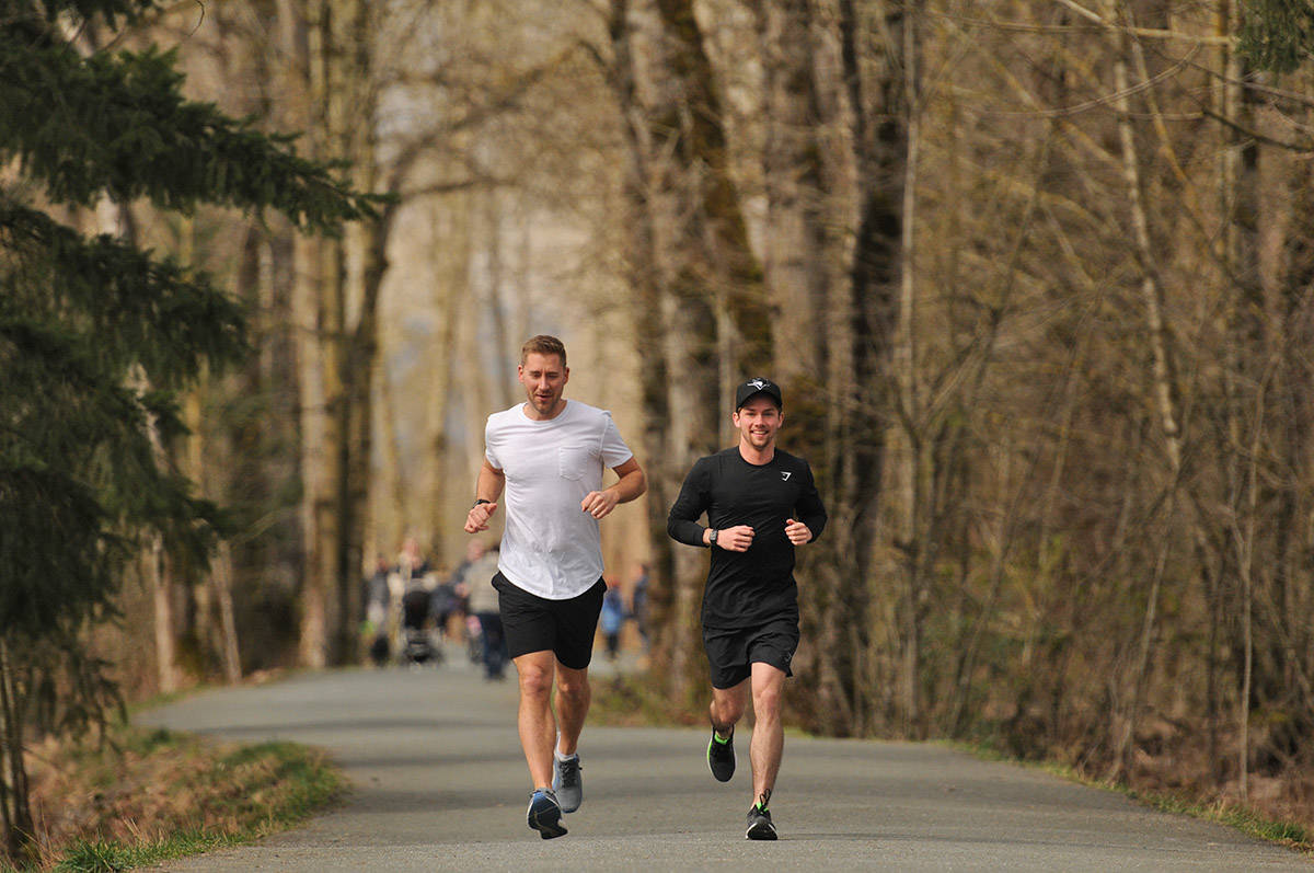 Chilliwack Realtor Jayden Lee (right), along with his buddy Cameron Van Klei, will be running to BC Childrens Hospital on Oct. 2 to raise money for the medical facility that helped him during his teenage years when he was diagnosed with leukaemia. The two are seen here on March 23, 2021 on the Vedder Rotary Trail. (Jenna Hauck/ Chilliwack Progress)
