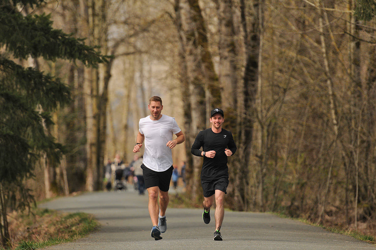 Chilliwack Realtor Jayden Lee (right), along with his buddy Cameron Van Klei, will be running to BC Childrens Hospital on Oct. 2 to raise money for the medical facility that helped him during his teenage years when he was diagnosed with leukaemia. The two are seen here on March 23, 2021 on the Vedder Rotary Trail. (Jenna Hauck/ Chilliwack Progress)
