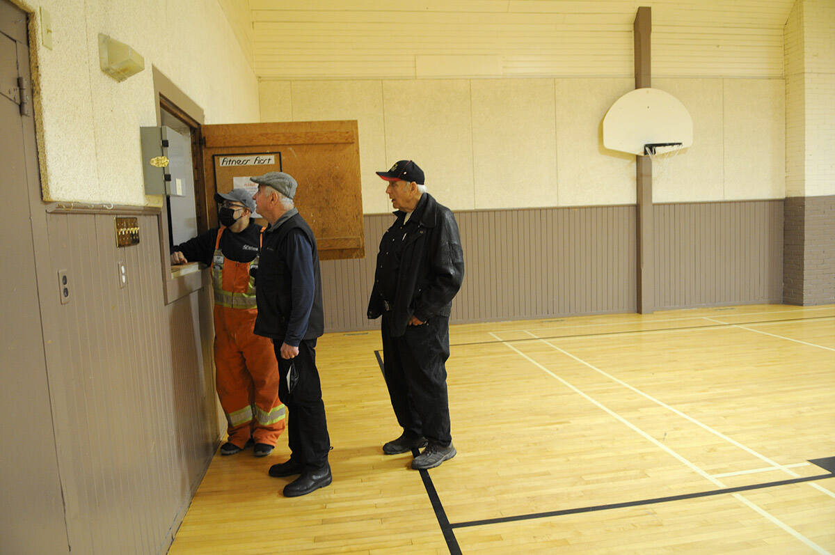 Pat MacPhail (right) and Bob Simpson with the Atchelitz Farmers Institute look at a detail at the Atchelitz Hall with City of Chilliwack worker Jaime Hernandez on Oct. 8, 2021. The AFI is in the process of closing down and they have gifted their property on Lickman Road to the City of Chilliwack. (Jenna Hauck/ Chilliwack Progress)