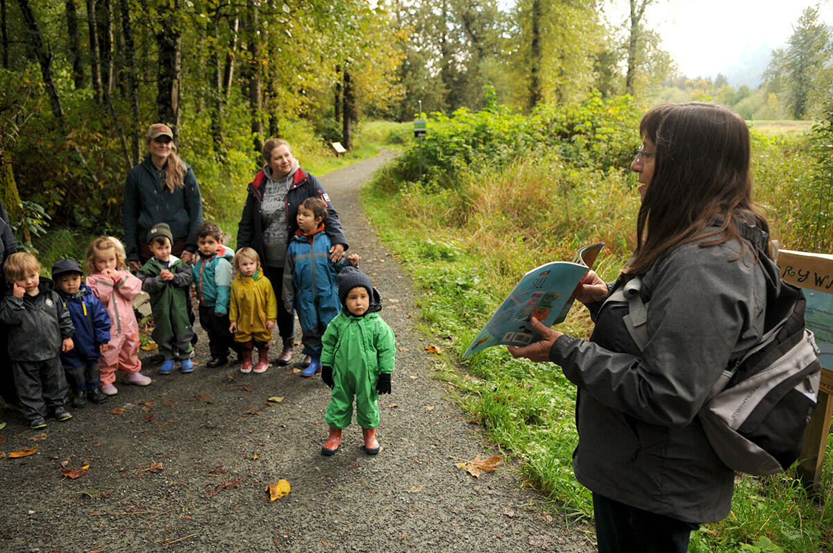 Wanda Lindsay (right) with the Yarrow Library welcomes preschoolers from Leap for Joy Open Air Learning to the launch of the Yarrow StoryWalk along the Beaver Loop Trail by the Vedder River in Yarrow on Thursday, Oct. 7, 2021. (Jenna Hauck/ Chilliwack Progress)