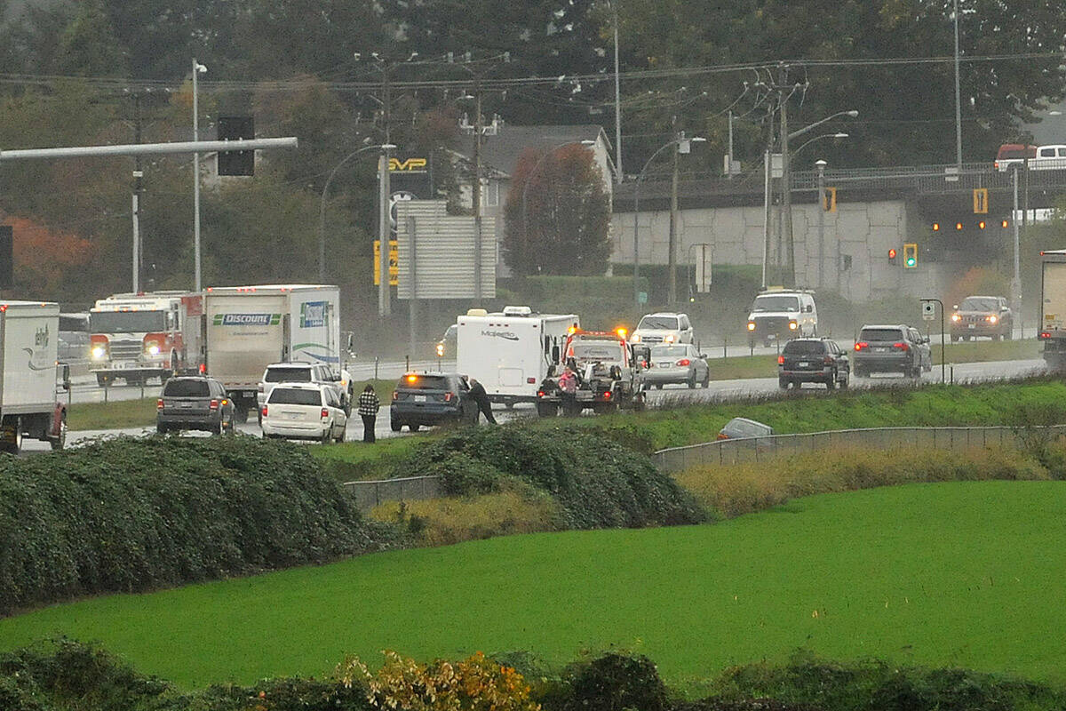 A car is seen in the ditch westbound on Highway 1 near the Vedder Road on-ramp on Friday, Oct. 15, 2021. (Jenna Hauck/ Chilliwack Progress)