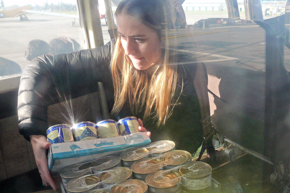 A volunteer loads supplies aboard an aircraft at the Langley airport for delivery to a flood-ravaged Fraser Valley community on Sunday, Nov. 21.(Dan Ferguson/Langley Advance Times)
