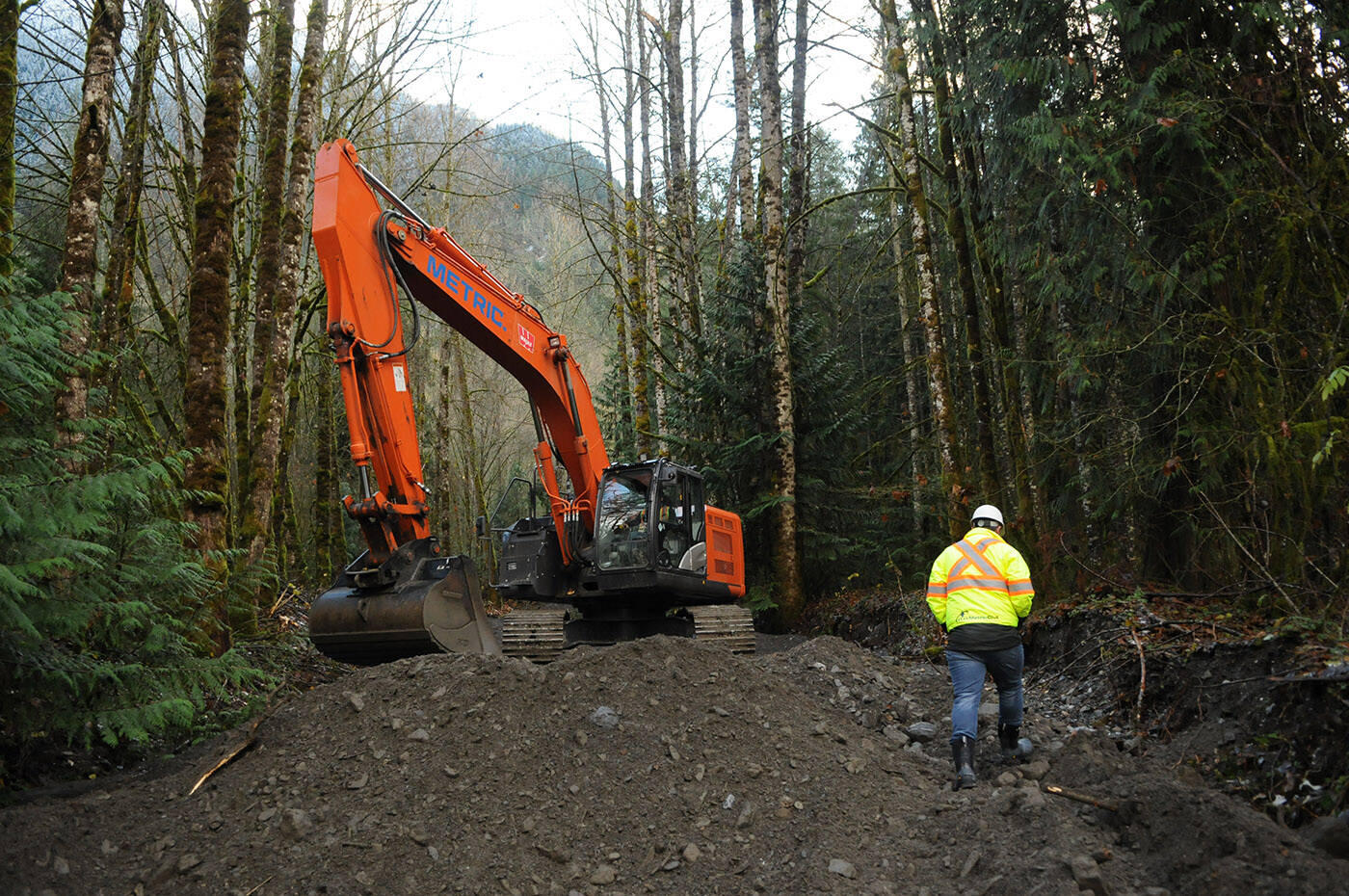 Crews with Metric Civil Contractors remove rocks and dirt on Friday, Nov. 19, 2021 after Pierce Creek was completely clogged. (Jenna Hauck/ Chilliwack Progress)