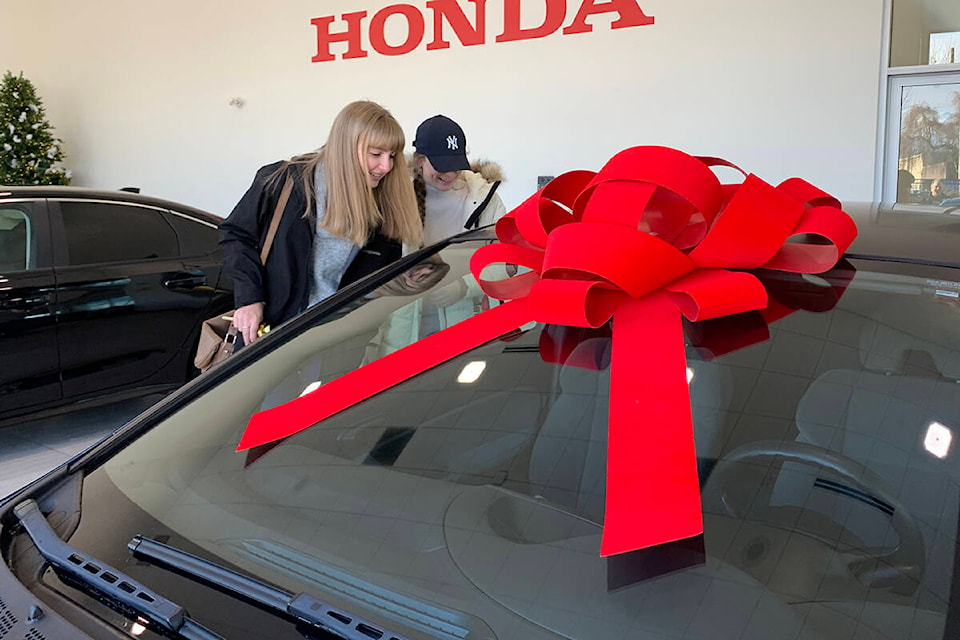 Sisters Jennifer (left) and Brianna Plett get a closer look at a Honda Civic Jennifer was nominated for after her family lost several cars in the flooding in Abbotsford. (Jessica Peters/ Abbotsford News)