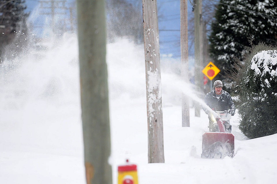 A man uses a snowblower along Wellington Avenue in Chilliwack on Thursday, Jan. 6, 2022. (Jenna Hauck/ Chilliwack Progress)