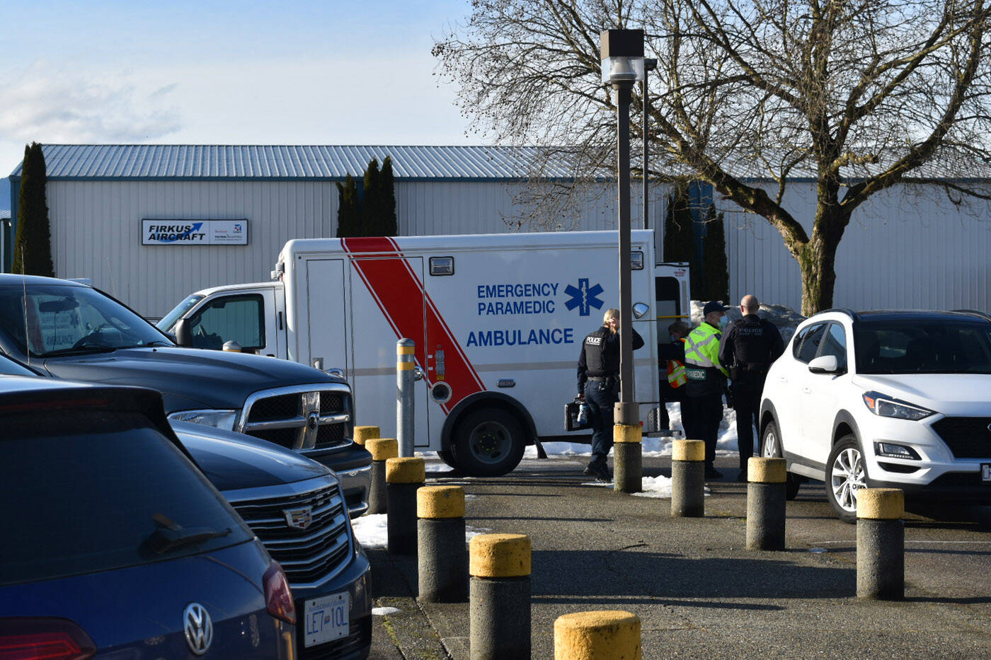 RCMP, paramedics and firefighters were at the scene of a crash on Young Road in Chilliwack where a dump truck went into a ditch on Friday, Jan. 14, 2022. A man suffered a head injury and had to be taken by air ambulance to hospital. Emergency crews are seen here at the Chilliwack Airport. (Mace MacGowan)