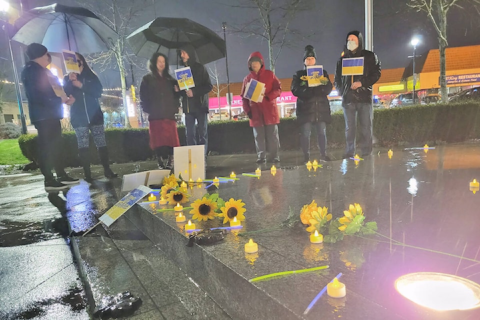 About 30 people took part in a Sunday night vigil in Langley for the Ukraine, gathering at the Vineyard church, then walking to the cenotaph in Douglas Park to place sunflowers, a symbol of the embattled country. (Dan Ferguson/Langley Advance Times)