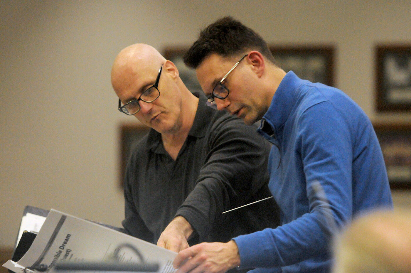 Vancouver baritone Andrew Greenwood (left) compares notes with Chilliwack Metropolitan Orchestra artistic director Gregory Johnson during rehearsal on Wednesday, March 16, 2022. (Jenna Hauck/ Chilliwack Progress)