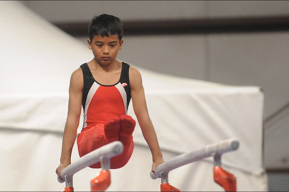 Nicholas Hajiadem with Abbotsford’s Twisters Gymnastics competes on the even bars during the Twisters Gymnastic Invitational at Chilliwack Heritage Park on Saturday, March 26, 2022. (Jenna Hauck/ Chilliwack Progress)