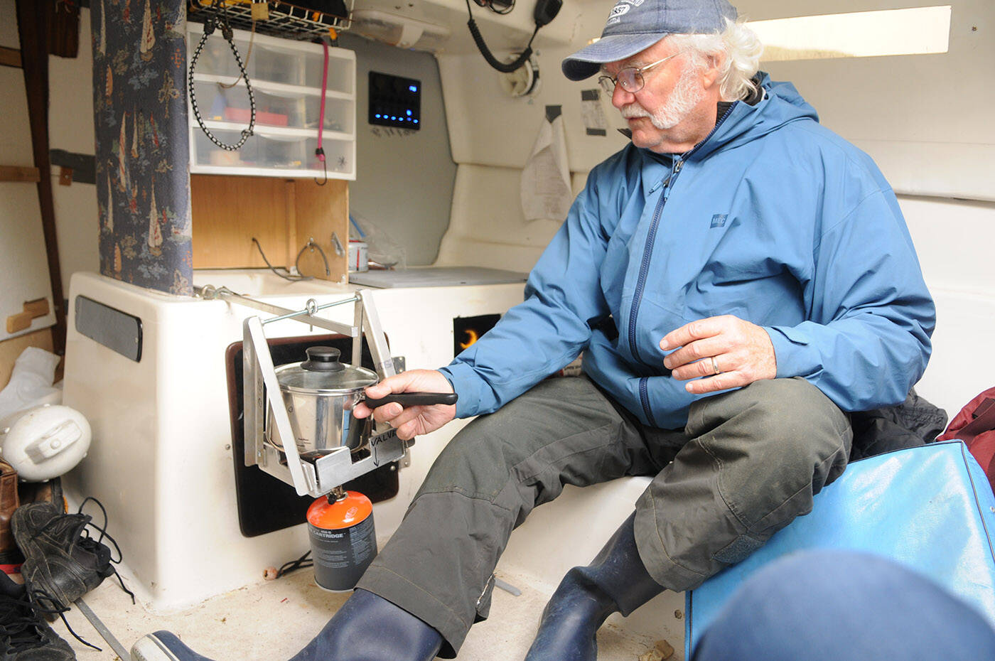 Randy Jensen shows how the gimbal stove works aboard his and his sons sailboat. (Jenna Hauck/ Chilliwack Progress)