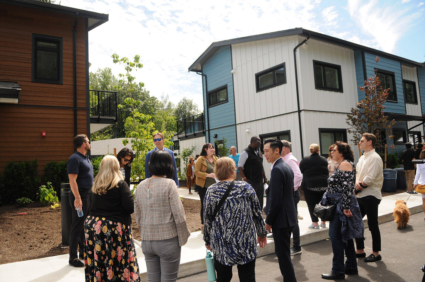 People gather outside the Tzeachten affordable housing project during the grand opening on Thursday, June 23, 2022. (Jenna Hauck/ Chilliwack Progress)