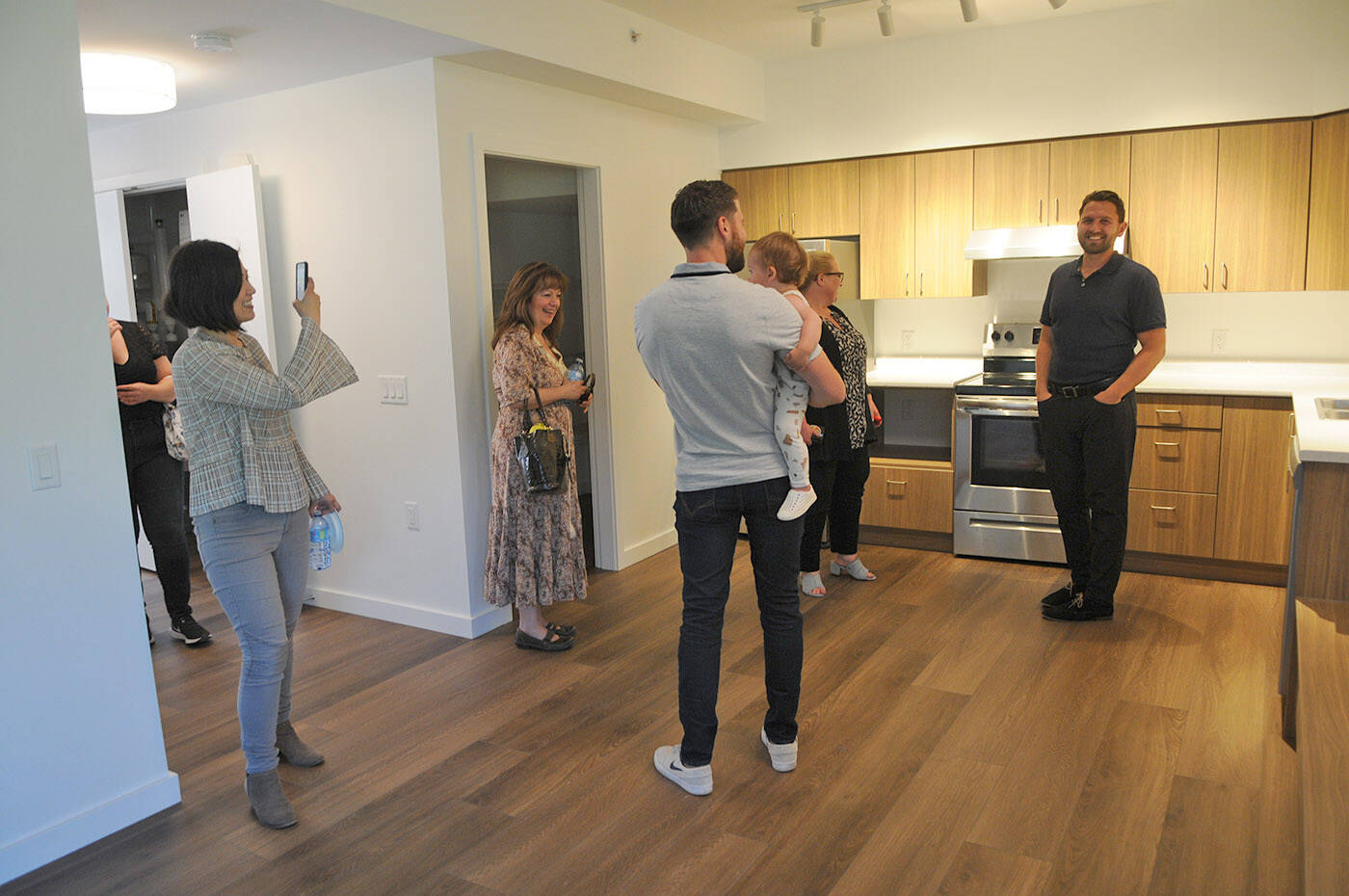 People tour the inside of one of the units at the Tzeachten affordable housing project on Thursday, June 23, 2022. (Jenna Hauck/ Chilliwack Progress)