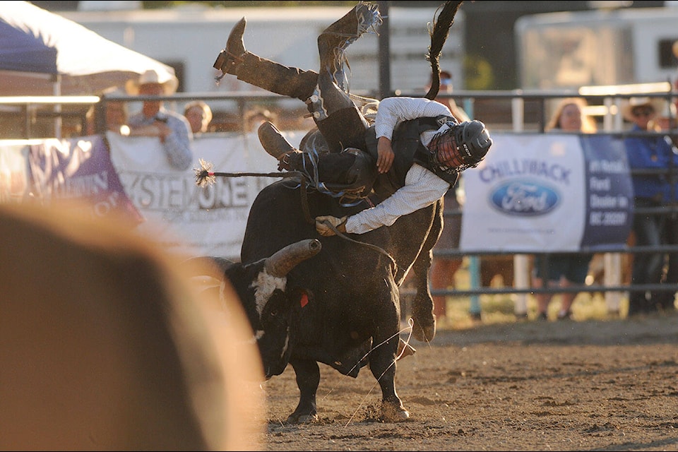 Justin William rides Anakin while competing in the bull riding event at the Chilliwack Rodeo during the 150th annual Chilliwack Fair at Heritage Park on Friday, Aug. 5, 2022. (Jenna Hauck/ Chilliwack Progress)