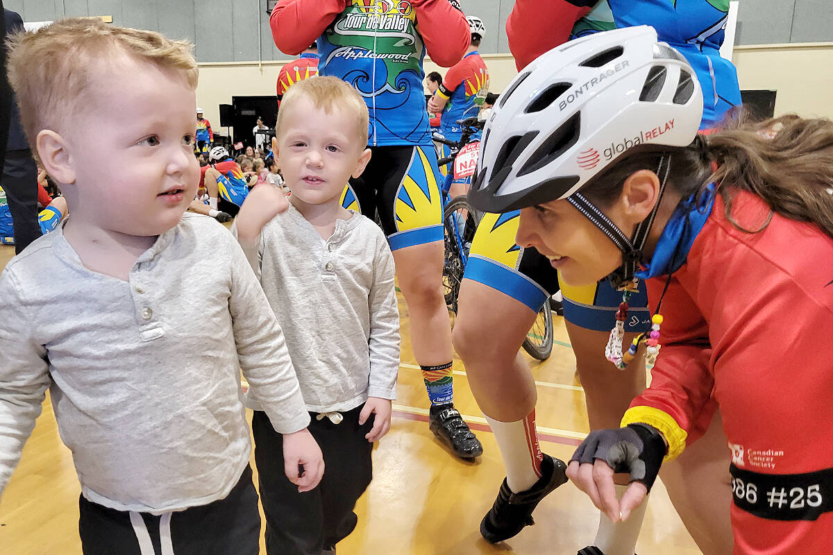 Twin brothers Bennett (left) and Weston, who have been diagnosed with identical cancers, were on hand to greet 34 riders on the Cops for Cancer Tour de Valley team as they began a nine-day, 800 kilometre journey through the Fraser Valley with a stop at at the Langley Fine Arts School. (Dan Ferguson/Langley Advance Times)