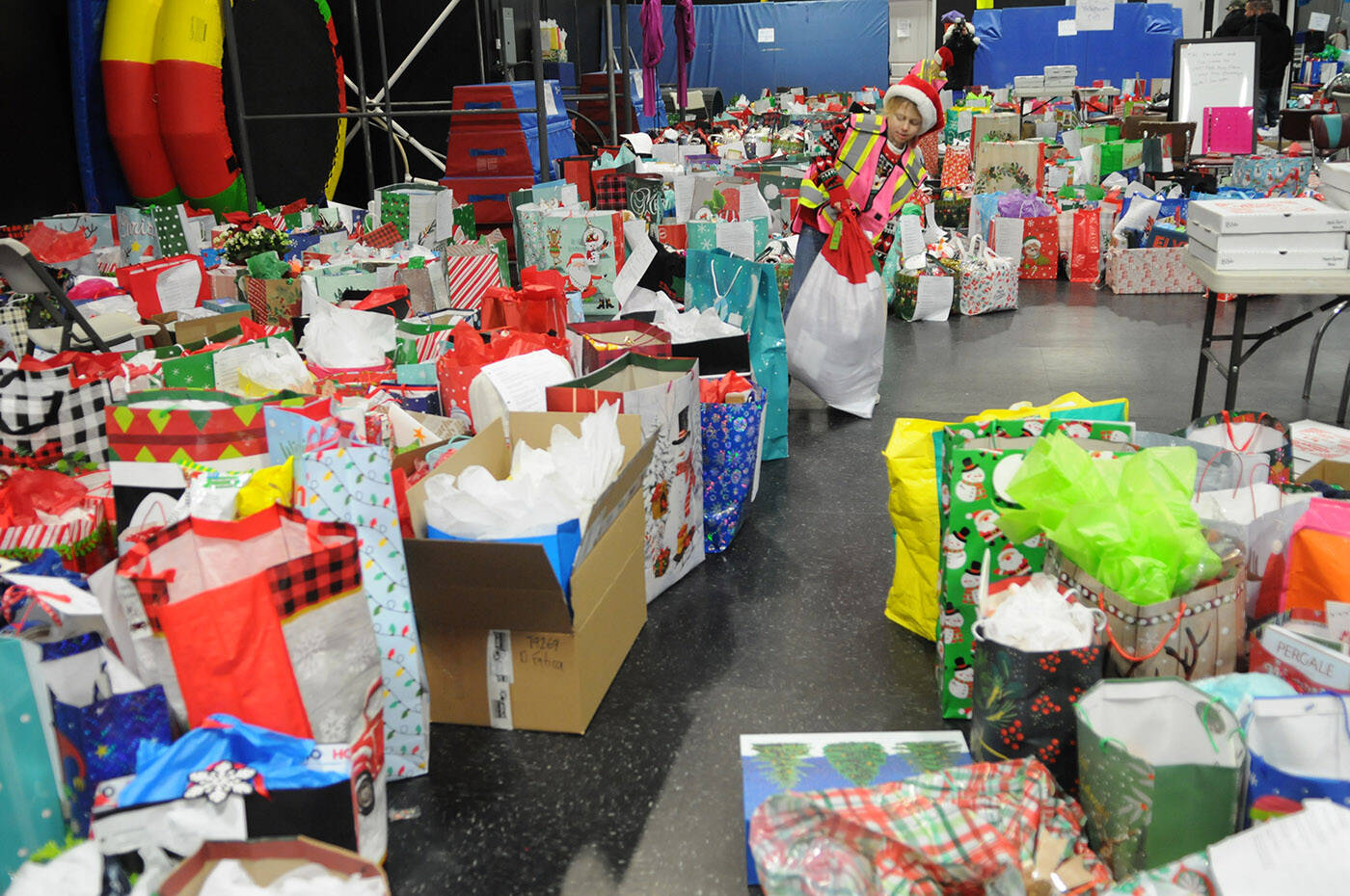 Hazel Milliard, 9, adjusts one of the 1,100 gifts donated as part of the third annual Adopt-A-Senior program on Saturday, Dec. 17, 2022. (Jenna Hauck/ Chilliwack Progress)
