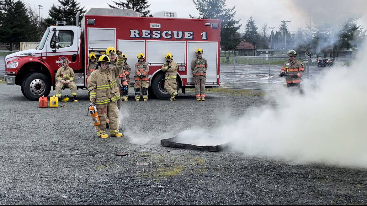 Lily Renaud of G.W. Graham Middle Secondary School (with fire extinguisher) is one of 90 teens from across Canada selected as a Loran Scholars Foundation finalist, and she has a chance to win an award valued at more than $100,000. She is seen here taking part in the Chilliwack Youth Firefighter Program in March 2022. (Submitted by Lily Renaud)