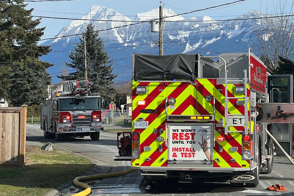 Chilliwack fire crews at the scene of a house fire at the corner of Garden Drive and Charles Street just after 2 p.m. on Feb. 24, 2023. (Paul Henderson/ Chilliwack Progress)