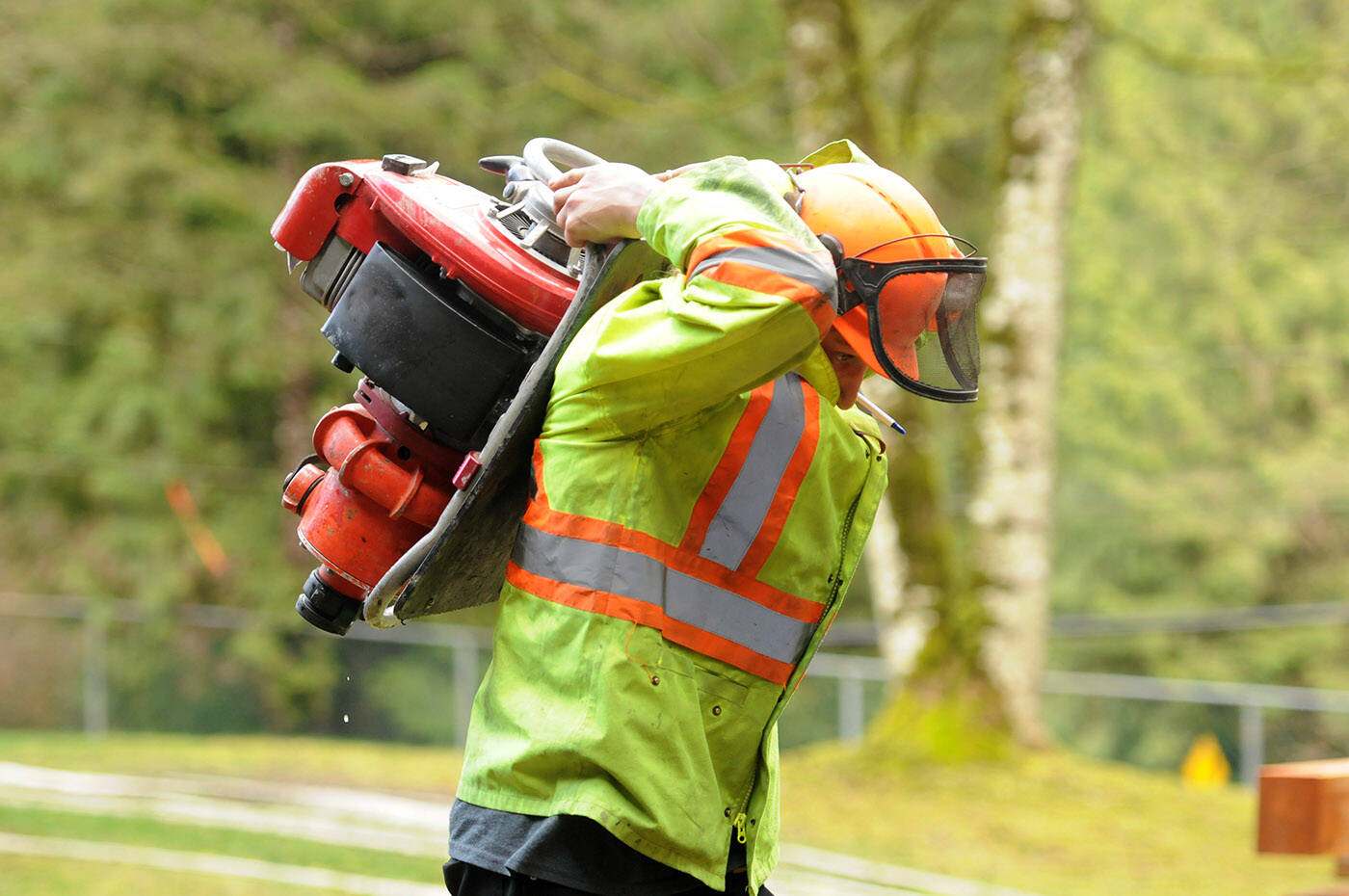 Kayleb Anhorn carries equipment to set up a pump and hose at a creek during the Junior Fire Crew work experience program at BC Wildfire Services Cultus Lake Fire Base on Saturday, March 25, 2023. (Jenna Hauck/ Chilliwack Progress)