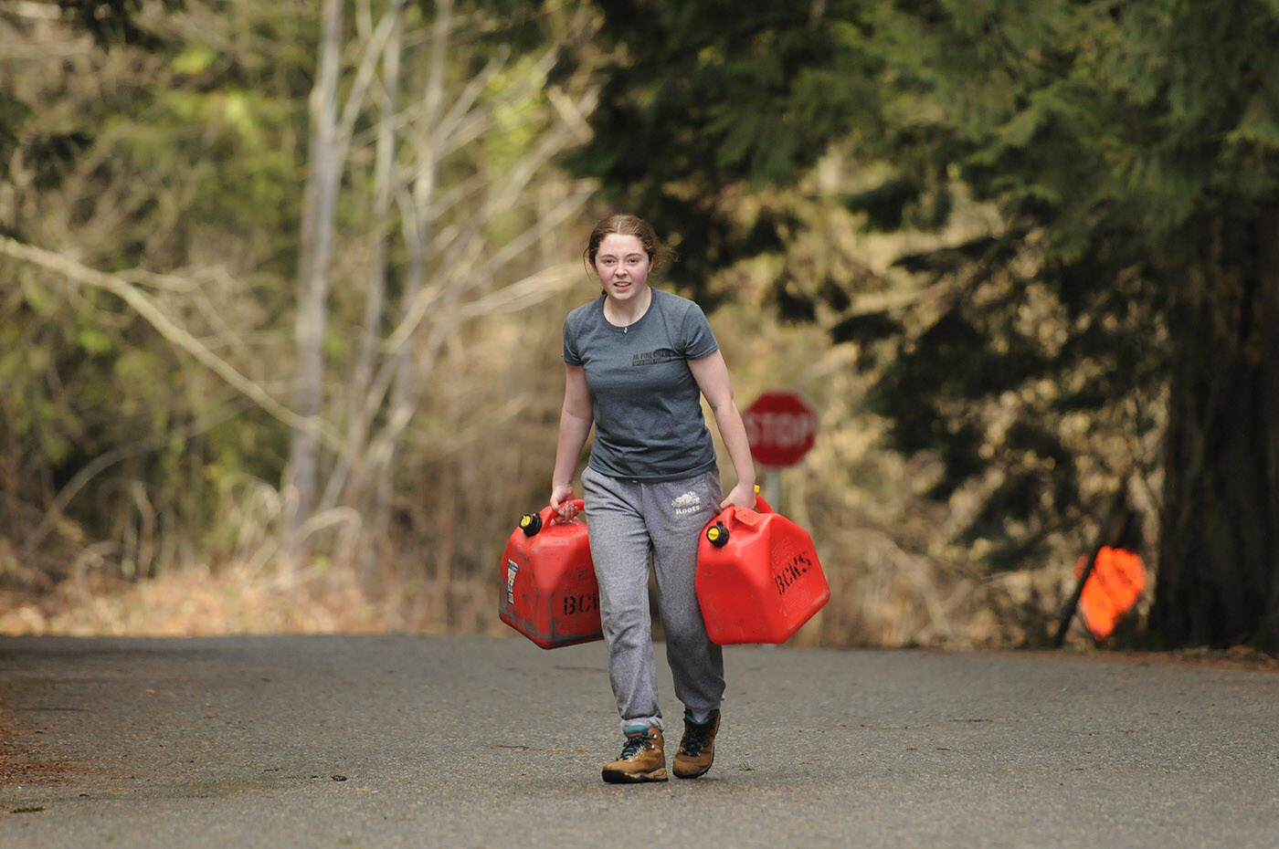 Talia Coward carries jerry cans during an obstacle course on the last day of the Junior Fire Crew work experience program at BC Wildfire Services Cultus Lake Fire Base on Saturday, March 25, 2023. (Jenna Hauck/ Chilliwack Progress)