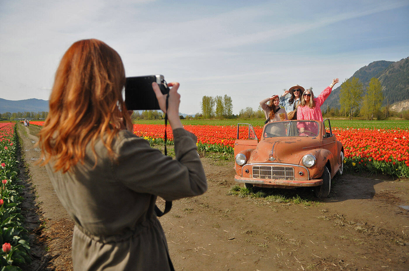 Morgan Sommerville uses a Polaroid camera to take a photo at the Chilliwack Tulip Festival on Thursday, April 27, 2023. (Jenna Hauck/ Chilliwack Progress)
