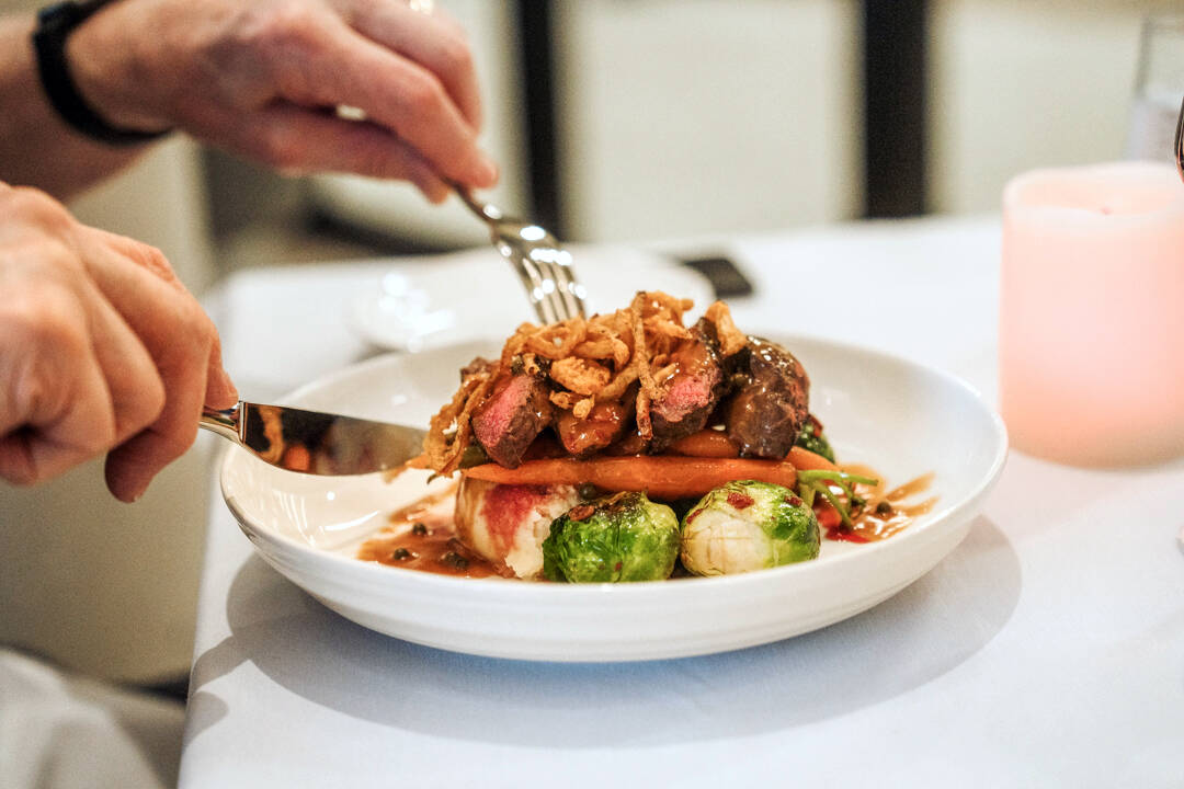 The delicious Peppercorn Flat Iron Steak served at The Summit Dining Room.