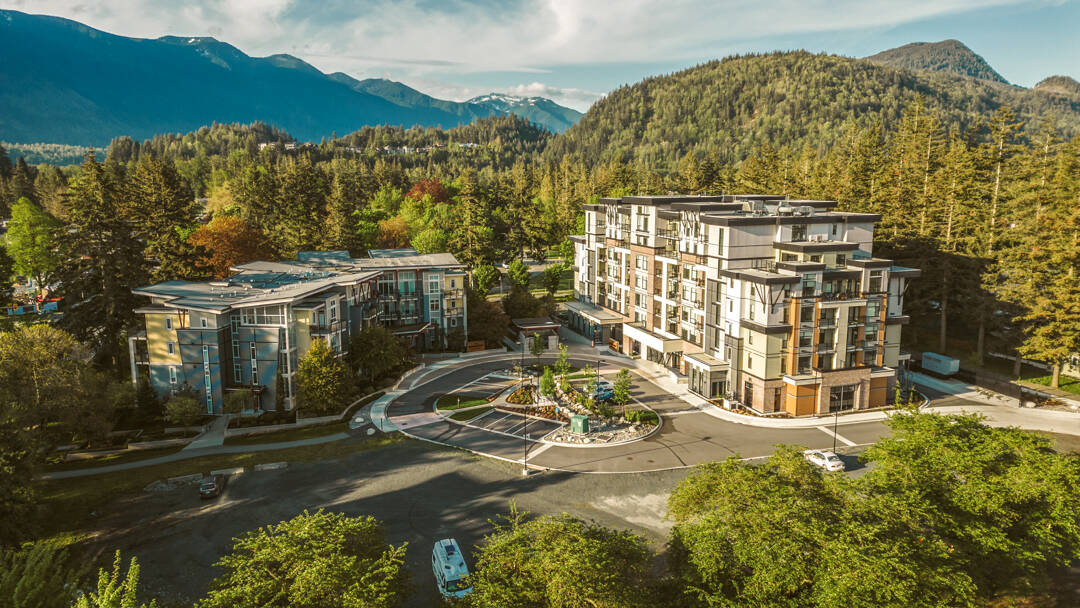 Mature, luscious trees, flat grounds, and beautiful mountains surround The Hawthorn building (right).