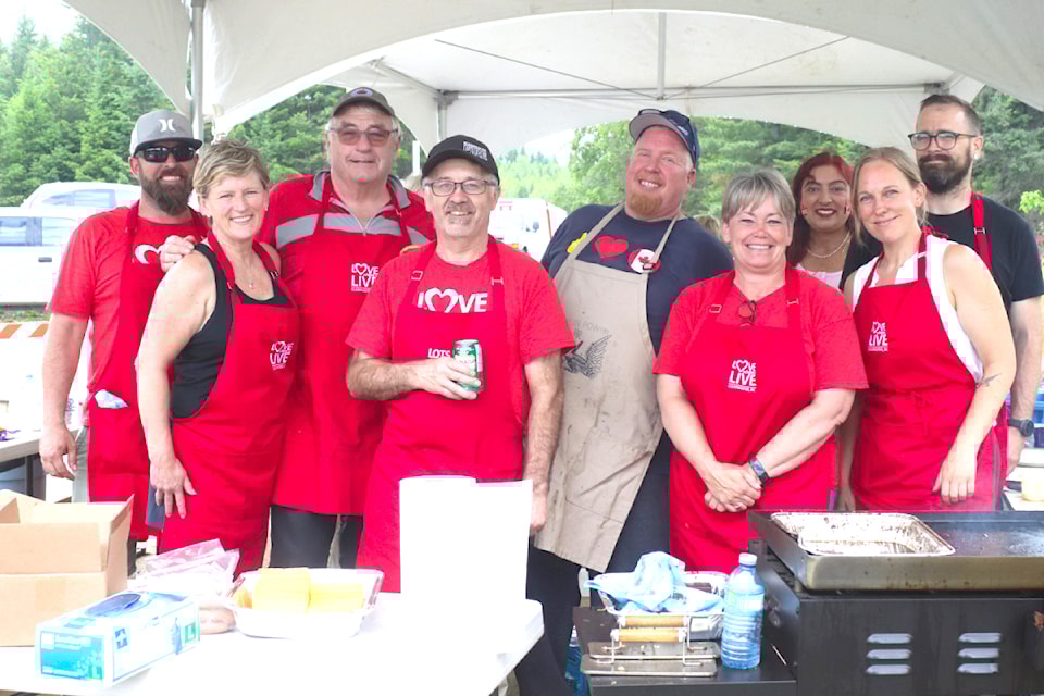 The District of Clearwater barbecue gang celebrating Canada Day. (From Left to Right): DOC councillor - Lyle Mackenzie, DOC councillor - Shelley Sim, DOC councillor - Ken Matheson, deputy fire chief - Guy Holland, DOC mayor - Merlin Blackwell, DOC  councillor - Theresa Braaten, Harjit Sandhu, Liane Culp, and DOC councillor - Bill Haring.
Photo / Zephram Tino 