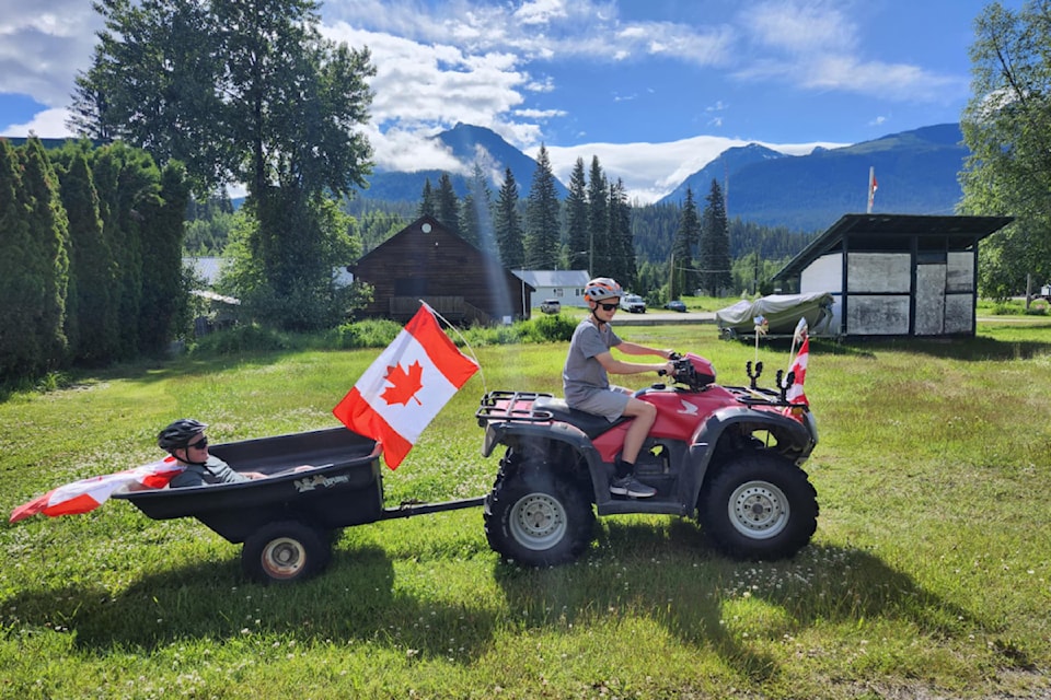 (From Left to Right): Richard Onslow and Woodrow Galbraith waving flags for the Canada Day parade in Blue River.