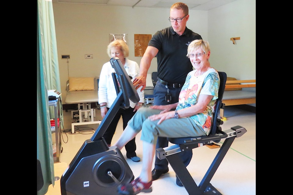 Photo 1: Physiotherapist Kyle Heppner, middle, shows Auxiliary members Marg Anderson, right, and Marilyn Collison, left, the new $1,700 Recumbent Bike, which is a safe and effective piece of equipment to work on staying fit with. It’s easier to access because there’s no middle bar to step over and therefore more beneficial for clients. These two pieces of equipment will also be used by Forest View Place residents.