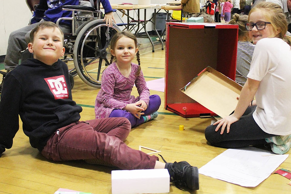 Raft River Elementary School students Ezra Mann, Seersha Marshall, and Emelia Rotzetter work on their design skills while building prototypes for an outdoor learning area for the facility during Maker Day late last month. Photo by Jaime Polmateer