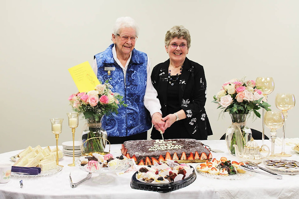 Gertie McKeown and Gail Capostinsky, long-time members of the Dr. Helmcken Memorial Hosptial Auxiliary, cut the cake at the group’s 50th anniversary celebration on March 12. Photo by Jaime Polmateer