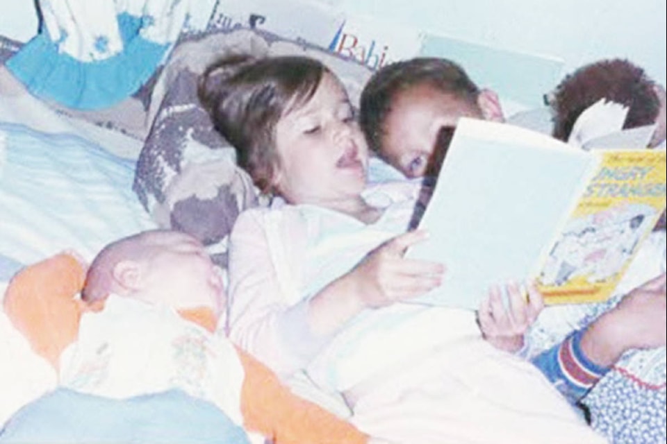 Eleanor Deckert homeschooled her children in the late 1980s and 90s and suggests splitting up the learning into one-third academic, one-third family business and one-third community service. Pictured, her kids David, Miriam, and Johnathen practise the academic portion by reading literature in 1987. Photo by Kevin Deckert
