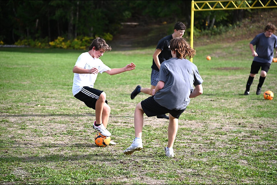 Theron McLarty, left, keeps the ball away from Alex von Hollen during a soccer practice drill to help players with their defensive moves. (Stephanie Hagenaars/Clearwater Times)