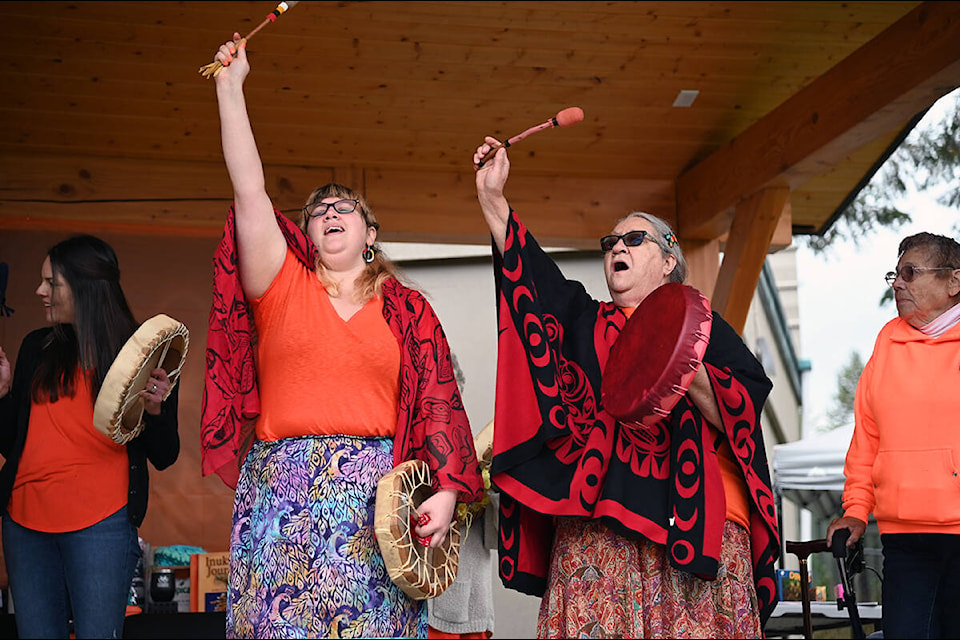 Brigette MacDougall, left, and Elder Sheila Nyman hold their fists in the air while singing the Women’s Warrior Song during a ceremony in recognition of Canada’s first National Day of Truth and Reconciliation on Thursday, Sept. 30, at the Dutch Lake Community Centre. (Stephanie Hagenaars/Clearwater Times)