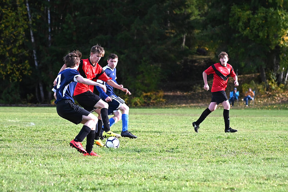 Owen Sim, middle, shows off some smooth deke skills to get around Teagan Lawhead and Landon Alward during the Clearwater and Barriere Secondary School soccer game on Tuesday, Sept. 28. (Stephanie Hagenaars/Clearwater Times)