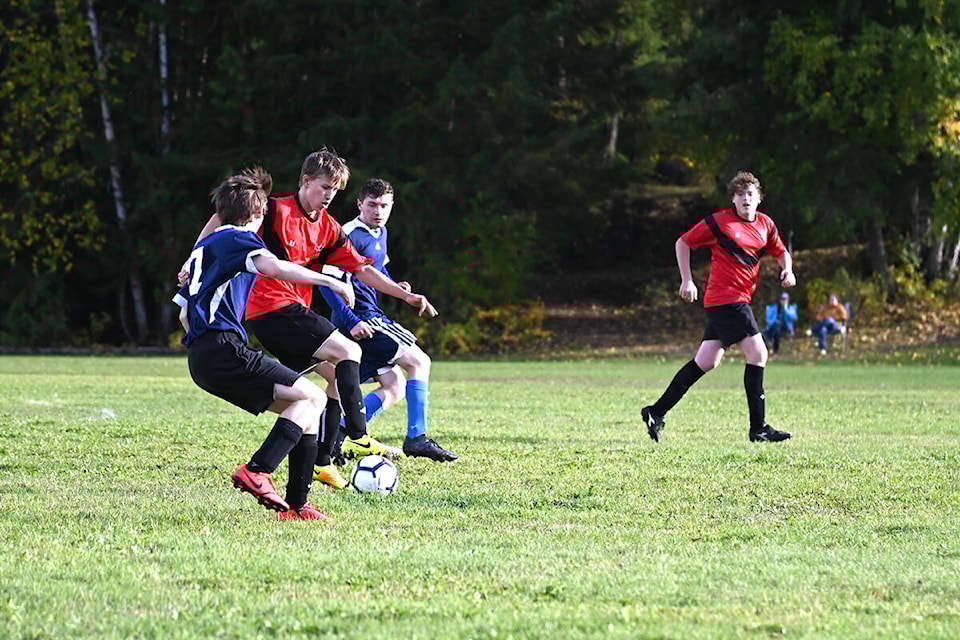 Owen Sim, middle, shows off some smooth deke skills to get around Teagan Lawhead and Landon Alward during the Clearwater and Barriere Secondary School soccer game on Tuesday, Sept. 28. (Stephanie Hagenaars/surgeryitaly)