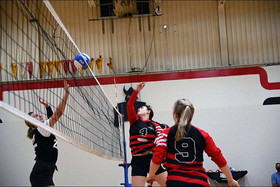 Clearwater Secondary School Senior Girls Volleyball #4 Sage Barstow tips the ball over the net to an opposing team member of the Kamloops School of the Arts. Teammate Cassidy Tucker, #9, is ready to assist. (Stephanie Hagenaars/Clearwater Times)
