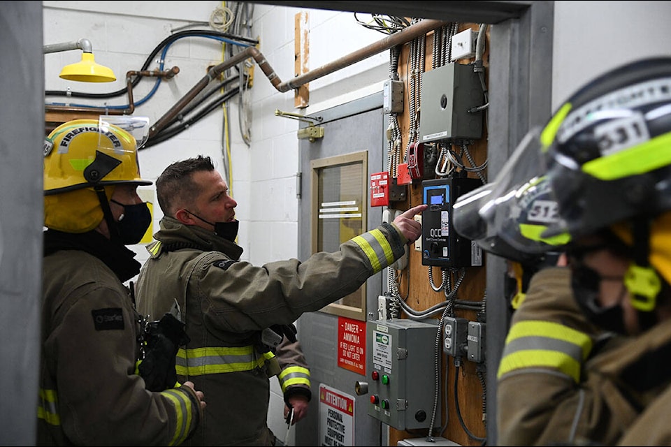 Clearwater Volunteer Fire Department Fire Chief Mike Smith explains to firefighters how the ammonia refrigeration system works at the North Thompson Sportsplex before beginning a simulation exercise. (Stephanie Hagenaars/Clearwater Times)