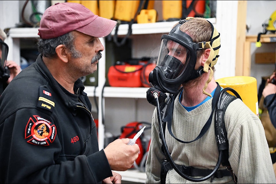 Captain Mike Poitras (left) puts firefighter Cole Simpson’s SCBA mask under a fit test. (Stephanie Hagenaars/Clearwater Times)