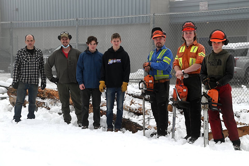 Clearwater Secondary School students and faculty spent a Friday morning bucking up a few logs from the clear cut trail made for the Trans Mountain pipeline expansion project. From l-r: CSS principal Darren Coates, woodshop teacher Dayton Fraser, Soren Coates, Owen Sim, local danger faller Clyde MacLennan, Tyne MacLennan and Olin Coates.