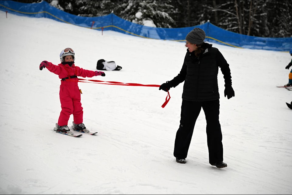Esther Helmer, 5, felt she was floating as she made her way down the bunny hill, with a little help from mom Kyla Ives. The two were enjoying some winter fun on New Year’s Day (Jan. 1), the first day of the season at the Clearwater Ski Hill. (Stephanie Hagenaars/Clearwater Times)