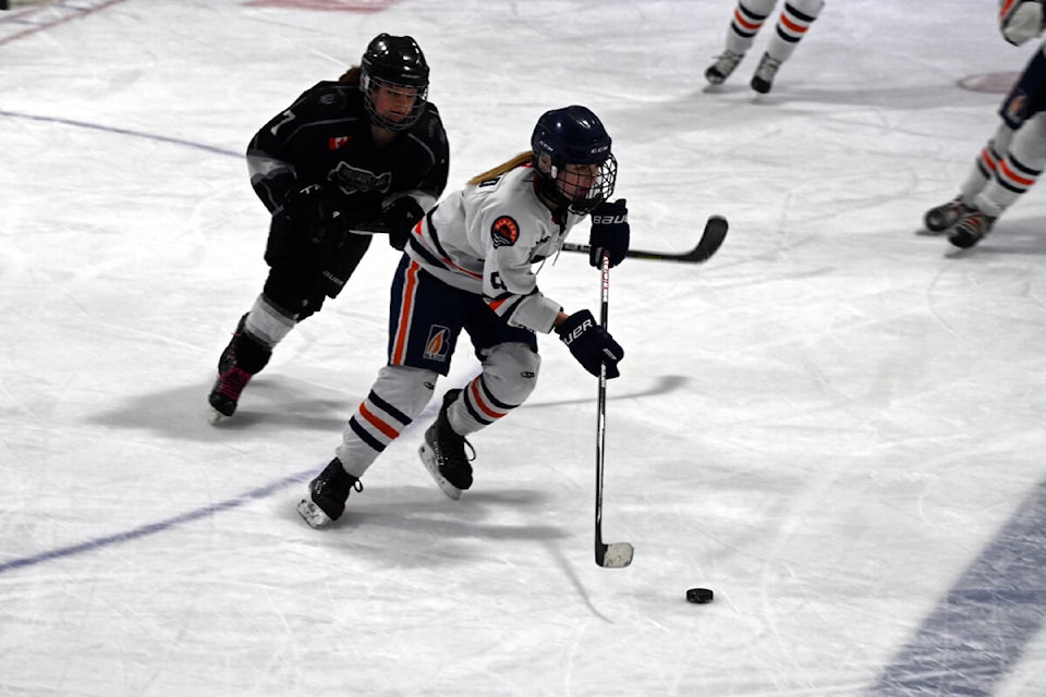 Kamloops Jr. Blazers #8 Lily MacLeod gets ahead of Timberwolves’ #7 Rachel Kennedy to bring the puck down to the other end of the ice and attempt a shot on goal. (Stephanie Hagenaars/Clearwater Times)