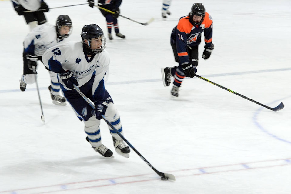 Clearwater U18 Icehawk Parker Collins takes the puck up the ice while Devin Holland backs him up. They were taking part in the first of two games against Logan Lake held at the Sportsplex in Clearwater on Saturday, Jan. 22. Photo by Keith McNeill.